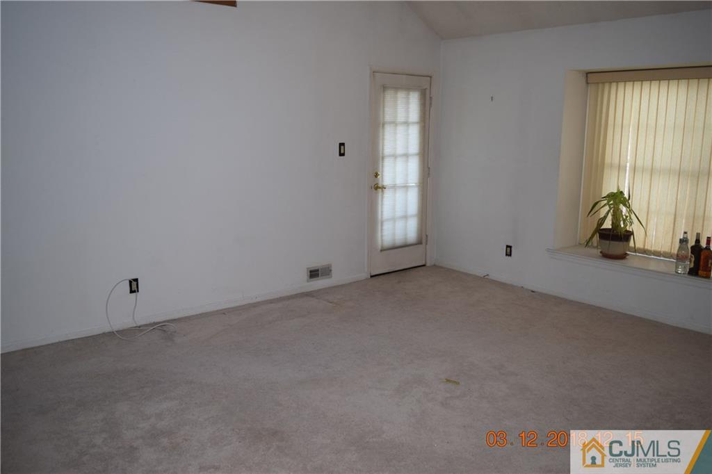 205 Commons Way, Unit 5 East Brunswick, NJ 08816 - Photo 4 of 10 an empty room with windows