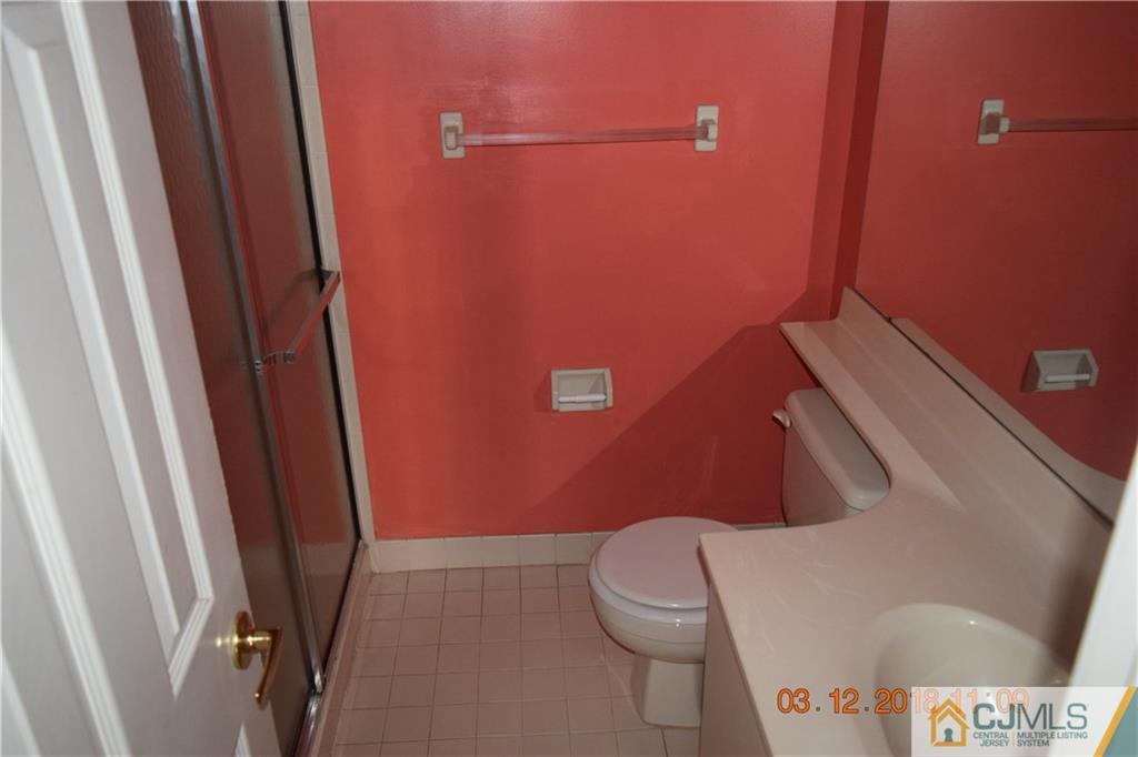 205 Commons Way, Unit 5 East Brunswick, NJ 08816 - Photo 8 of 10 a bathroom with a toilet and a shower