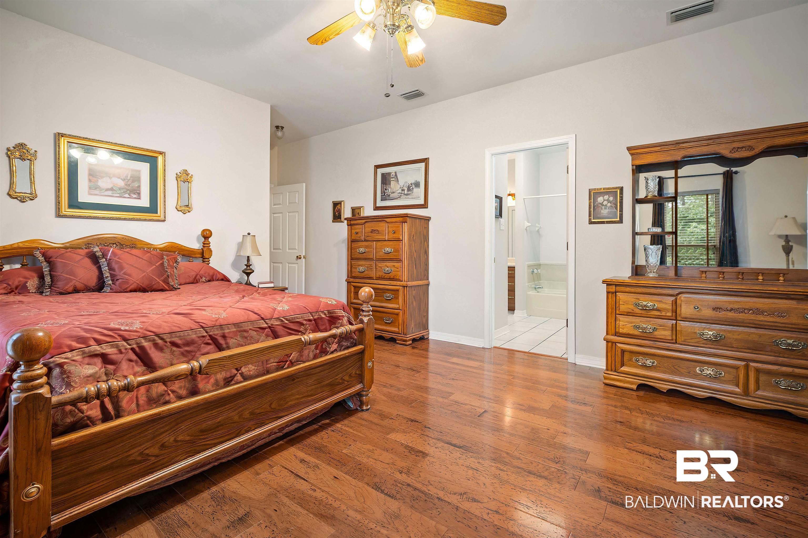 7419 Pake Road Saraland, AL 36571 - Photo 14 of 27 Bedroom with light hardwood / wood-style flooring, ensuite bath, and ceiling fan