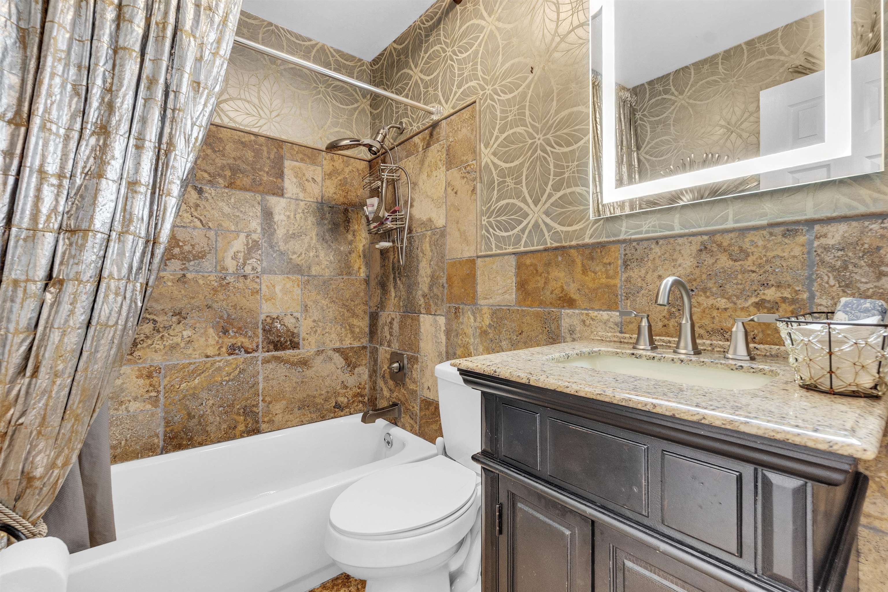 3029 Andy Road Memphis, TN 38109 - Photo 11 of 21 Full bathroom with shower / tub combo, toilet, vanity, wallpapered walls, and tile walls