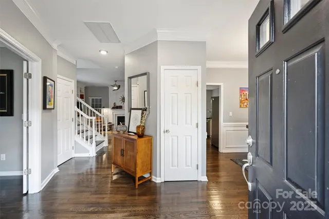 a view of a hallway with wooden floor and windows