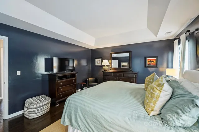 a bedroom with a bed and dresser