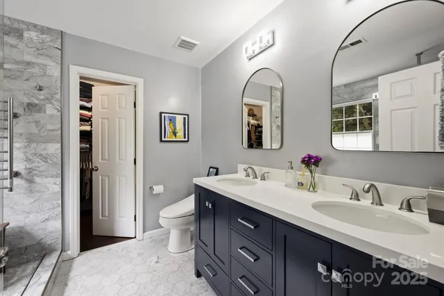a spacious bathroom with a granite countertop sink mirror and double