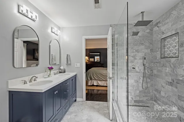 a en suite bathroom with a double vanity sink and a mirror