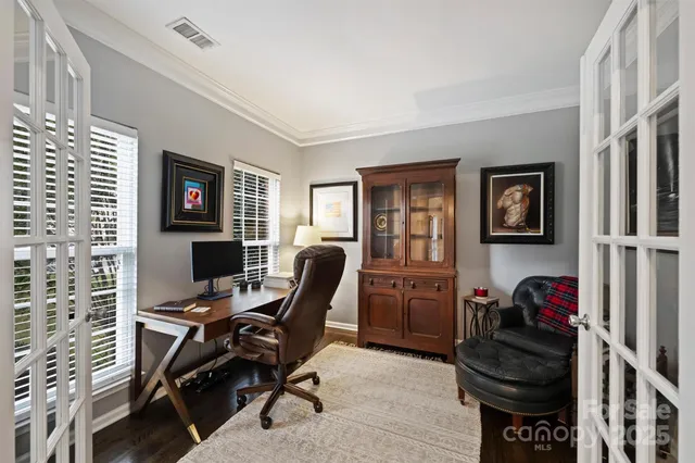 a view of a workspace with furniture and a window