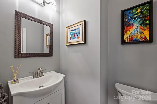 a bathroom with a toilet a sink and a mirror