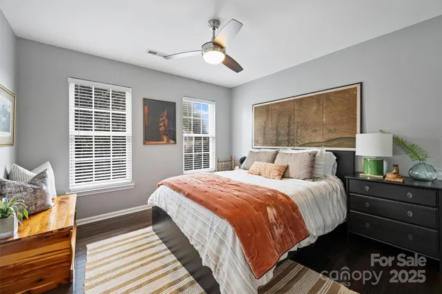 a bedroom with bed and wooden floor