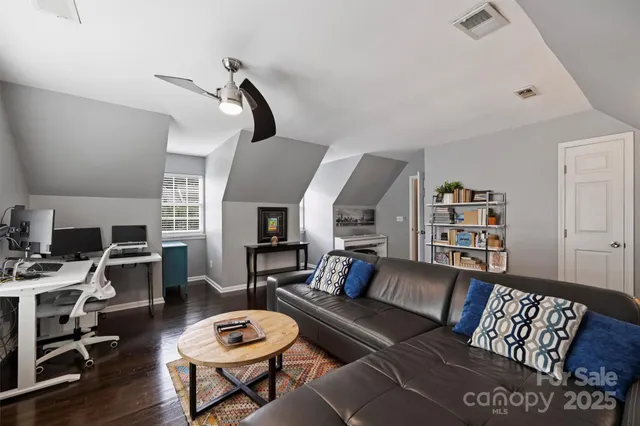 a living room with furniture a rug and a flat screen tv