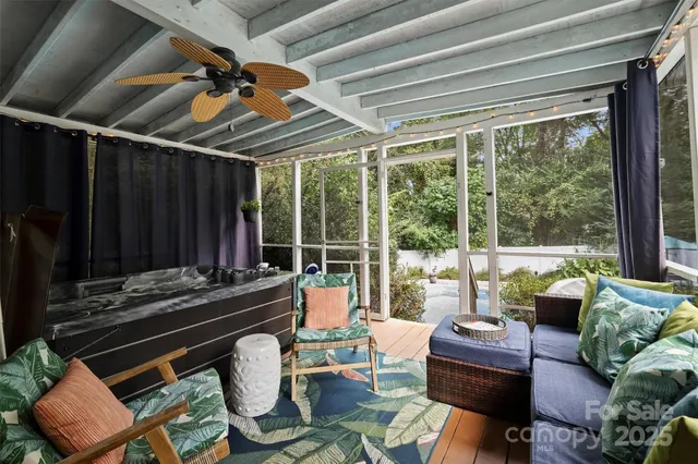 a living room with furniture and a floor to ceiling window