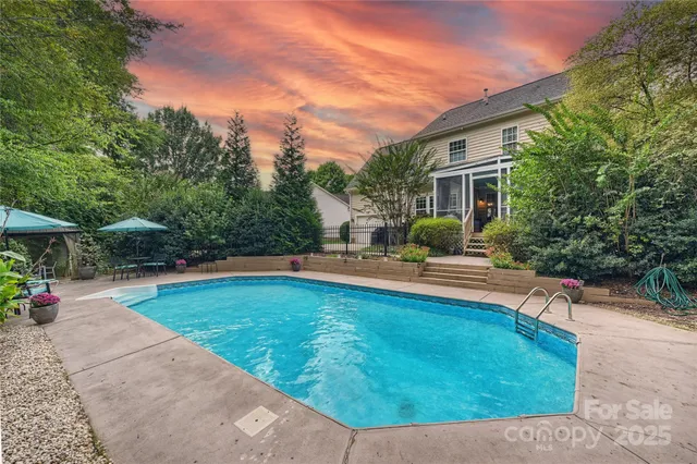 a view of a house with swimming pool and sitting area