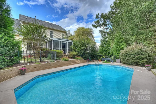 a view of backyard with swimming pool and outdoor seating