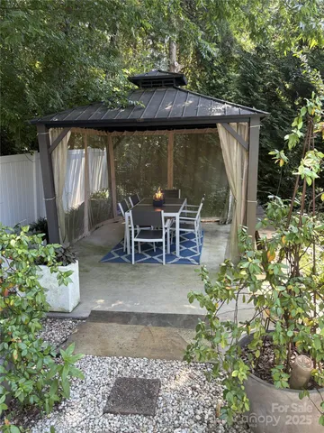 a view of a chair and table in the garden