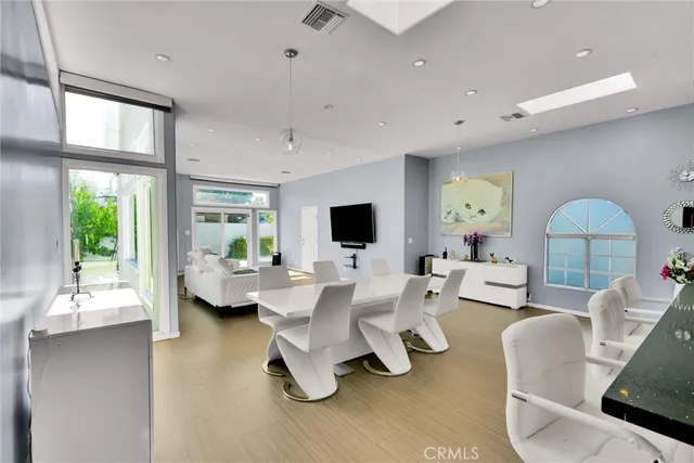 a living room with furniture fireplace and a large window