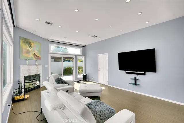 a living room with fireplace furniture and a flat screen tv