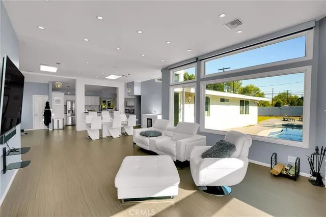 a living room with couches and a flat screen tv