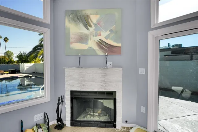 a living room with a fireplace and a floor to ceiling window