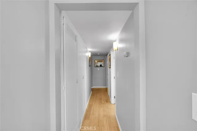 a view of a hallway with wooden floor