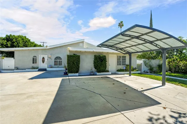 a patio with a table and chairs under an umbrella