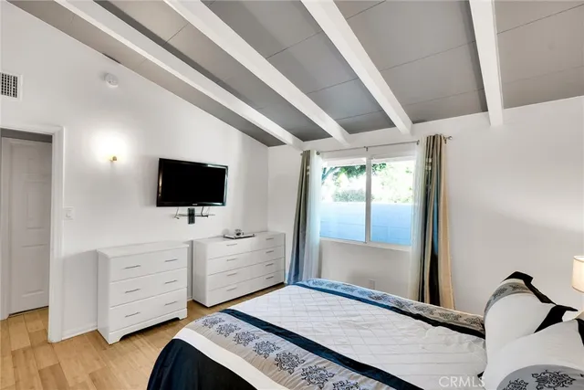 a bedroom with furniture and flat screen tv