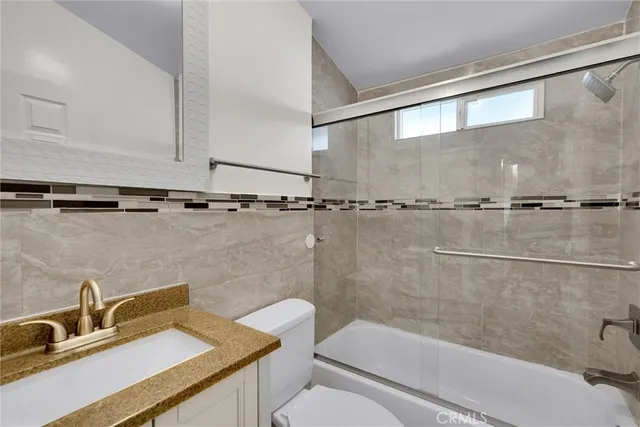 a bathroom with a sink a mirror and a toilet