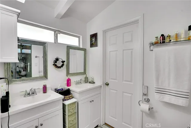 a bathroom with a sink vanity and mirror