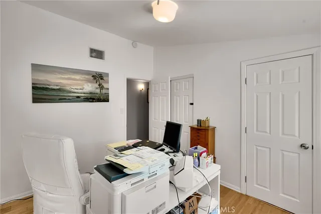 a bathroom with a granite countertop sink mirror vanity and toilet