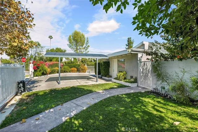a view of a house with backyard and sitting area