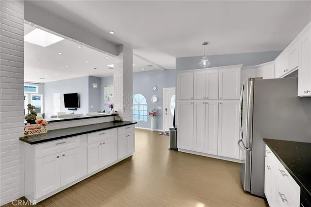 a large kitchen with a large counter top appliances and cabinets