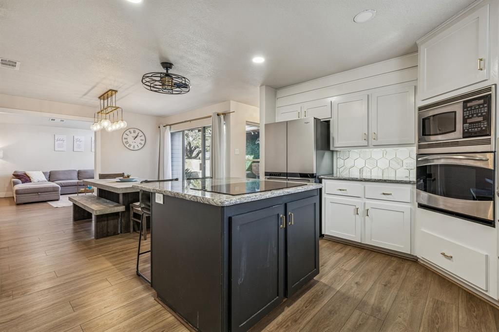4512 Ranch View Road Fort Worth, TX 76109 - Photo 15 of 40 a kitchen with stainless steel appliances granite countertop a stove and cabinets