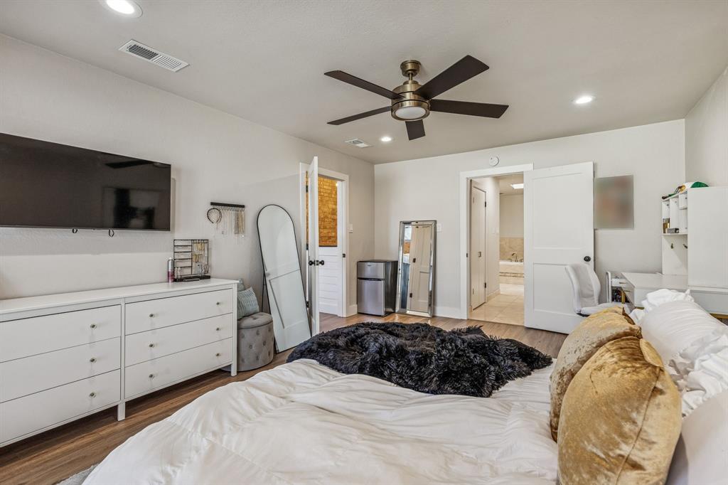 4512 Ranch View Road Fort Worth, TX 76109 - Photo 18 of 40 a bedroom with a large bed and a flat screen tv