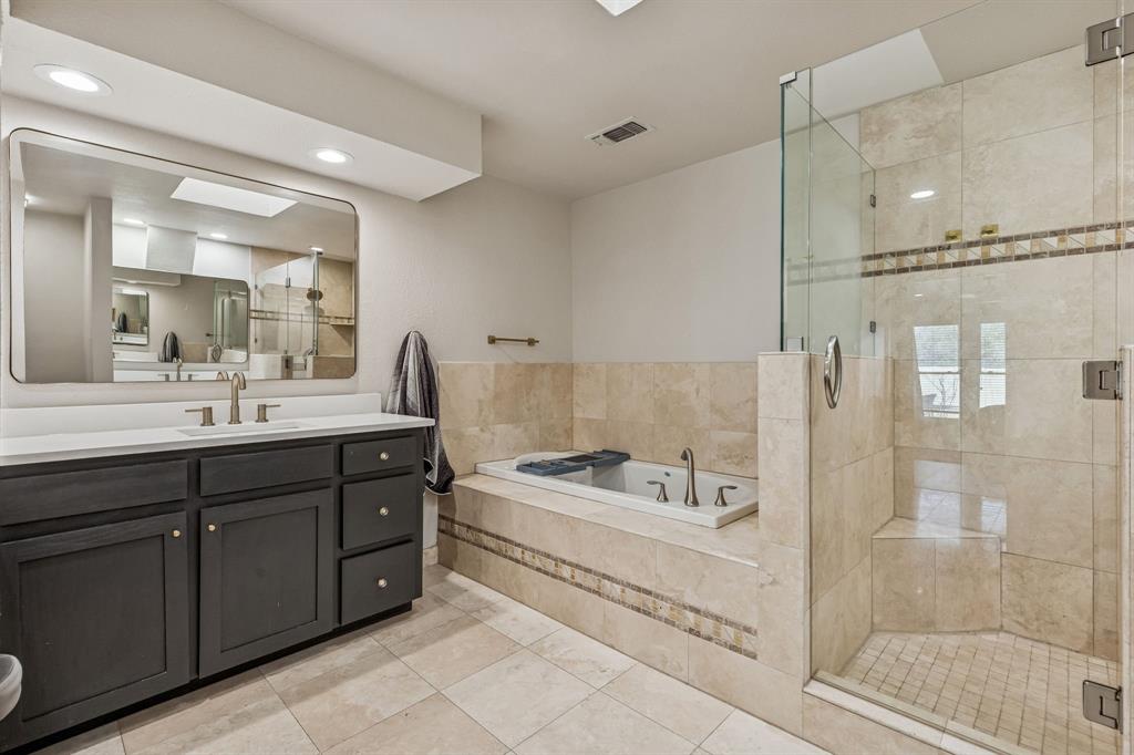 4512 Ranch View Road Fort Worth, TX 76109 - Photo 19 of 40 a bathroom with a tub a sink shower and mirror