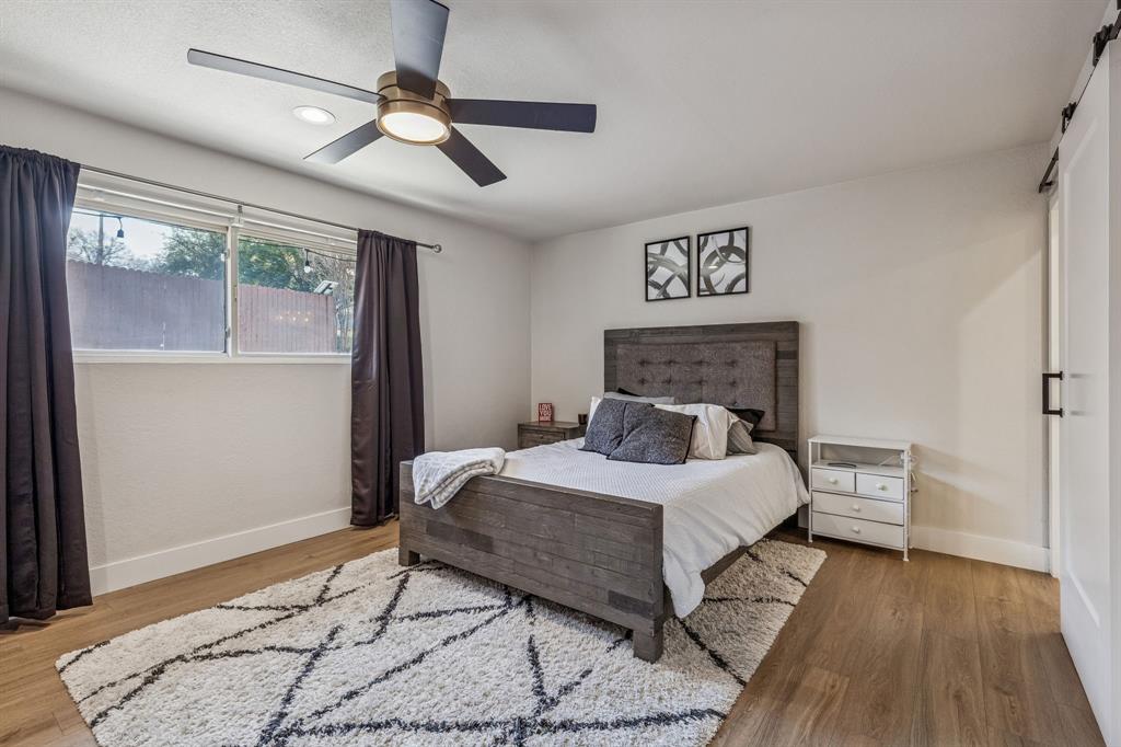 4512 Ranch View Road Fort Worth, TX 76109 - Photo 22 of 40 a bedroom with a bed and wooden floor