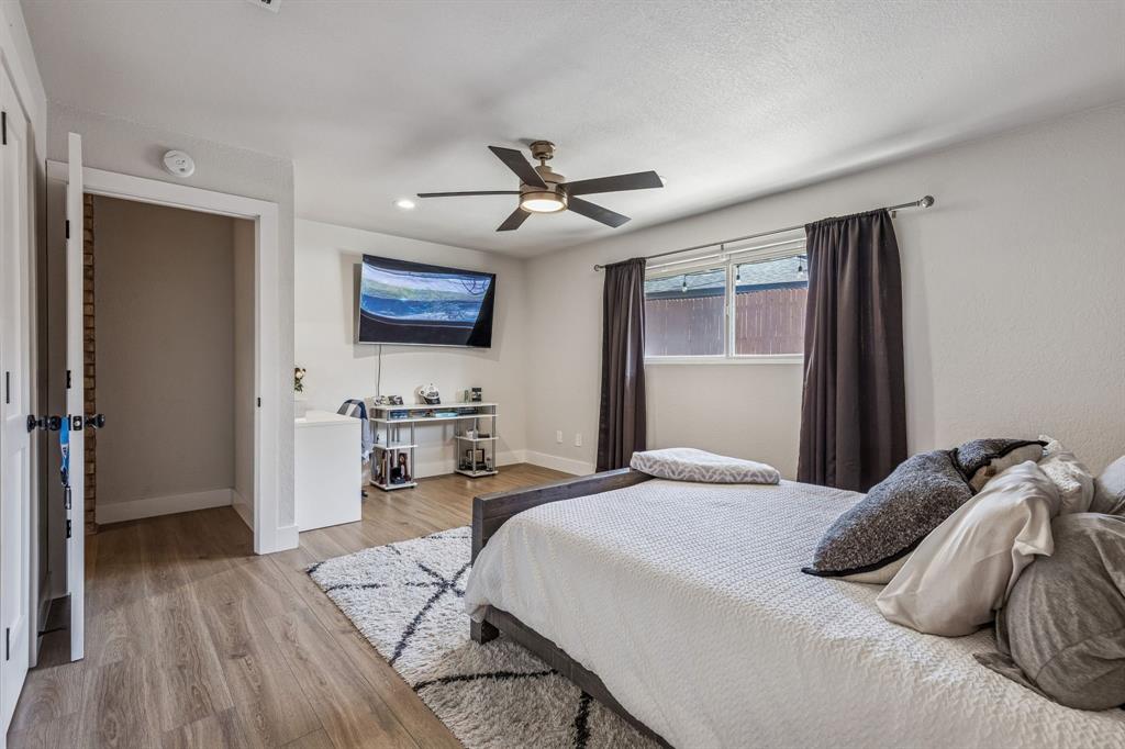 4512 Ranch View Road Fort Worth, TX 76109 - Photo 23 of 40 a bedroom with a bed and a ceiling fan