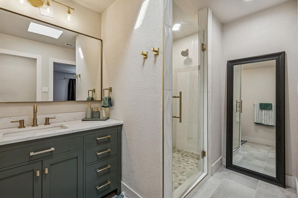 4512 Ranch View Road Fort Worth, TX 76109 - Photo 25 of 40 a bathroom with a granite countertop sink shower and a mirror