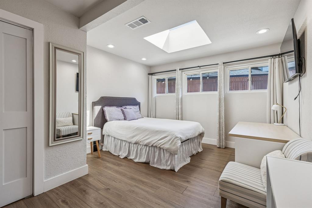 4512 Ranch View Road Fort Worth, TX 76109 - Photo 26 of 40 a bedroom with a bed and a large window