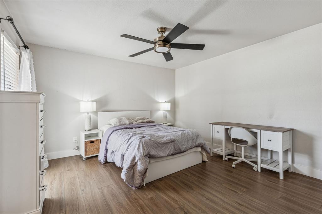 4512 Ranch View Road Fort Worth, TX 76109 - Photo 28 of 40 a bedroom with a bed and a chandelier
