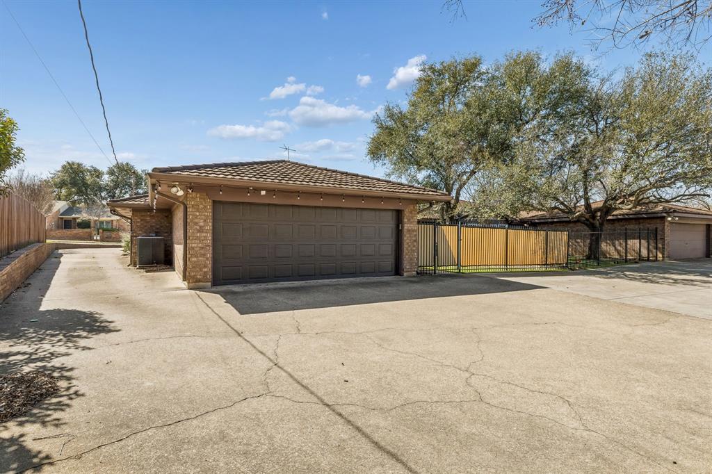 4512 Ranch View Road Fort Worth, TX 76109 - Photo 36 of 40 a front view of a house with a yard and garage