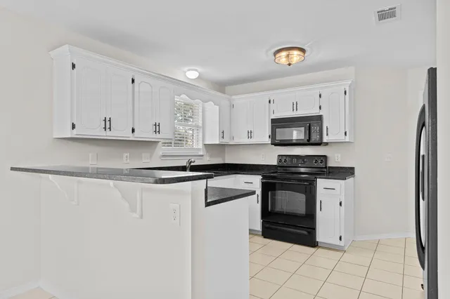 a kitchen with stainless steel appliances a refrigerator sink and cabinets