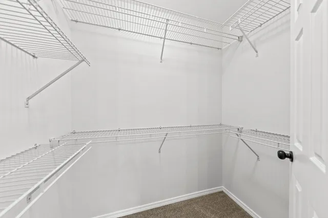 a bathroom with a granite countertop sink mirror vanity and toilet