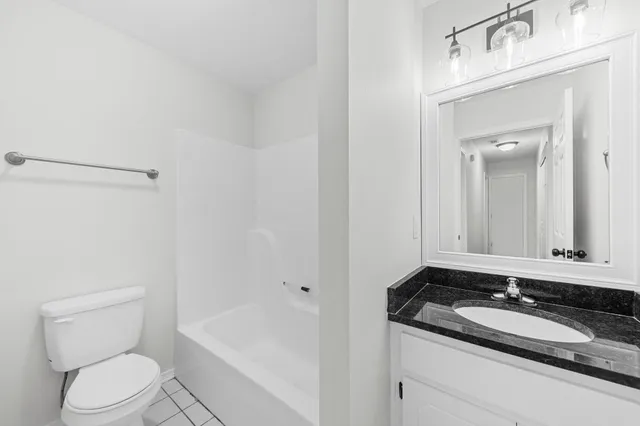 an empty room with a window and a ceiling fan