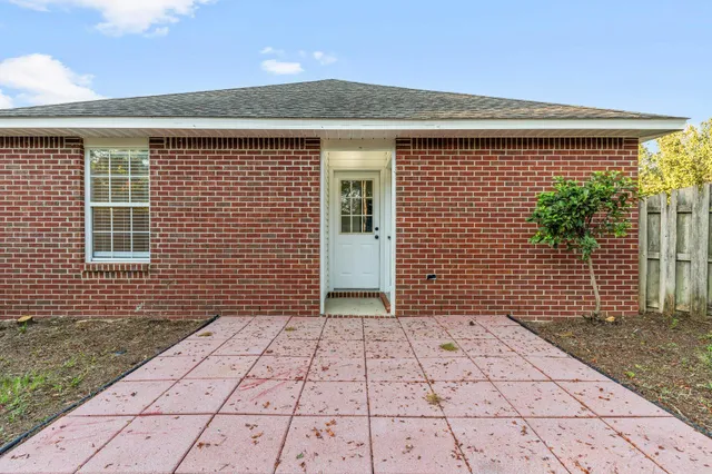 a view of a backyard with large tree