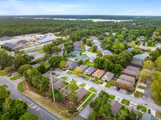 an aerial view of residential houses with outdoor space and street view