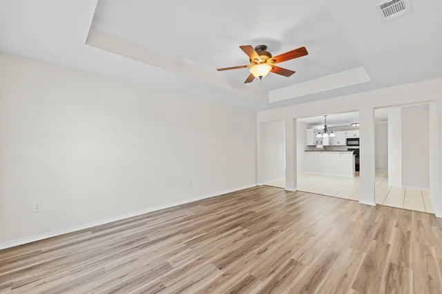 a view of empty room with wooden floor