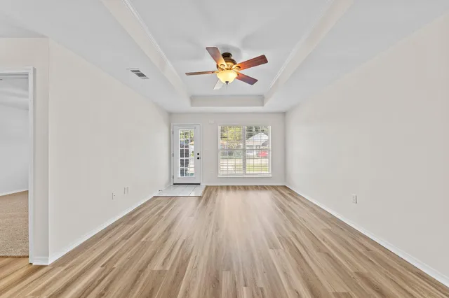 wooden floor in an empty room with a window