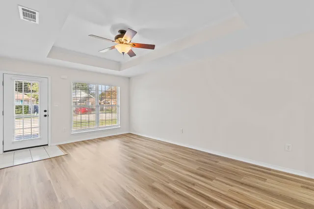 wooden floor in an empty room with a window