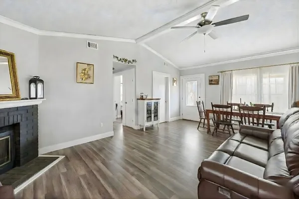 a living room with furniture and wooden floor