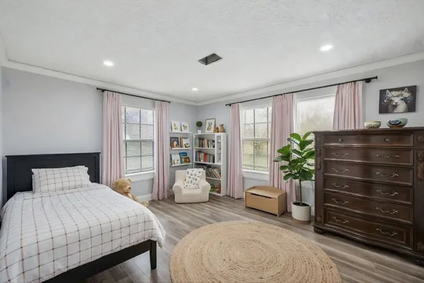 a bedroom with a bed and a television