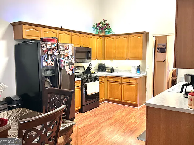 a kitchen that has a sink stainless steel appliances and cabinets
