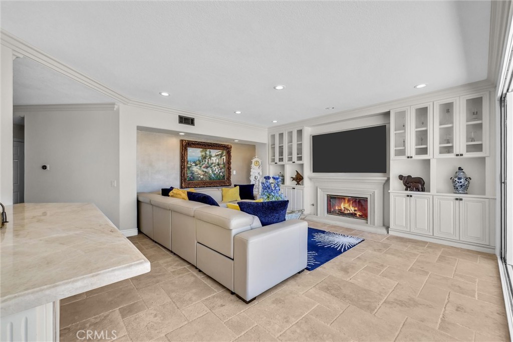 25672 Raintree Road Laguna Hills, CA 92653 - Photo 11 of 50 a living room with furniture a flat screen tv and a fireplace