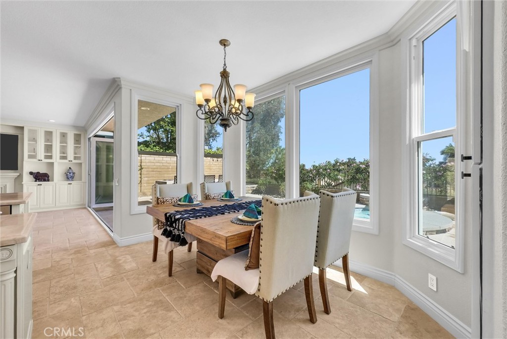 25672 Raintree Road Laguna Hills, CA 92653 - Photo 15 of 50 a living room with furniture and a chandelier